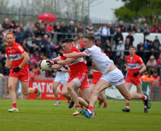 Derry’s Gareth McKinless charges past Tyrone’s Brian Kennedy during the Ulster Championship clash last May. Photo: George Sweeney. DER2218GS – 002