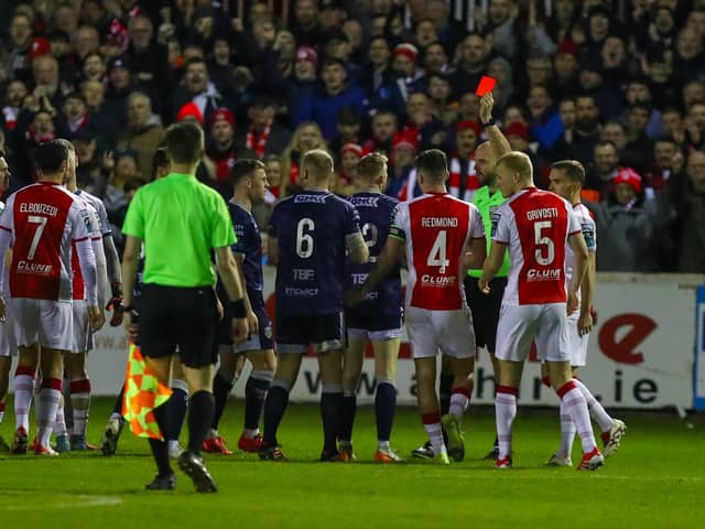 Carl Winchester is shown a straight red for his challenge on Mason Melia at Richmond Park on Monday night.
