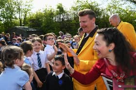 Pupils greet members of the Jive Aces at Rosemount Primary School during the Jazz Festival. Photo: George Sweeney