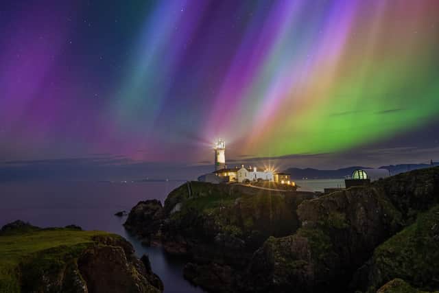 Patryk Sadowski's ‘Back on Earth – Landscape’ category for his image ‘Fanad Head – Aurora 2024’.