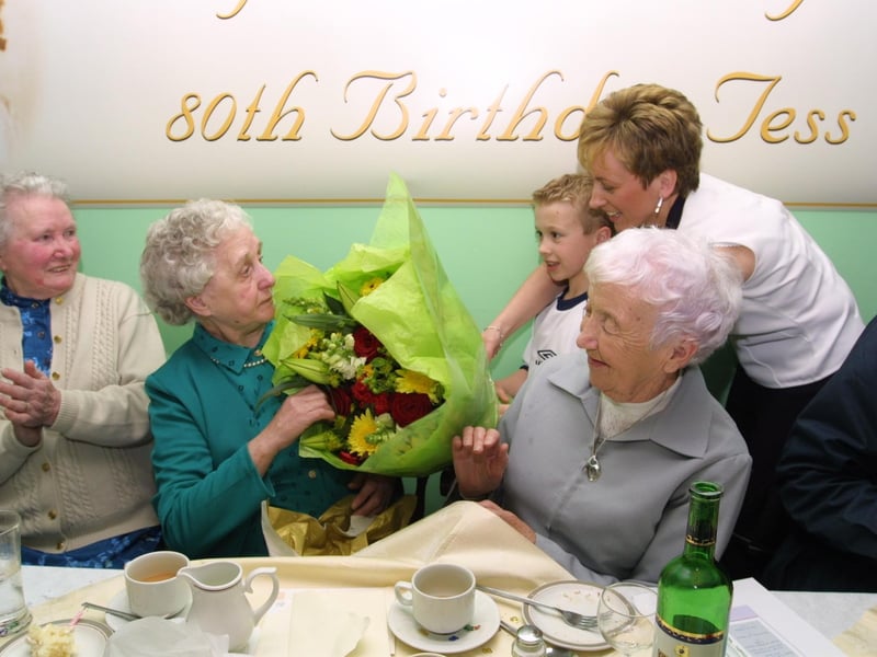Tess accepts flowers from her youngest grandchild Paul Nelis.