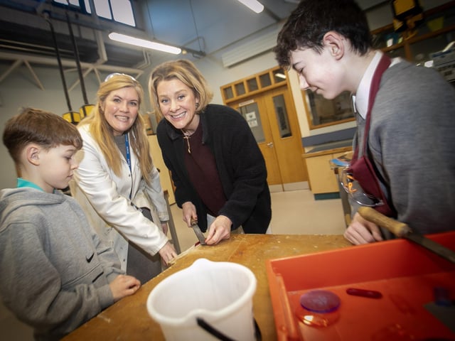Mum Mrs. Paula Pyke shows son Sam how to file, under the watchful eye of Mrs. Emma O'Donnell and Declan Kearney.