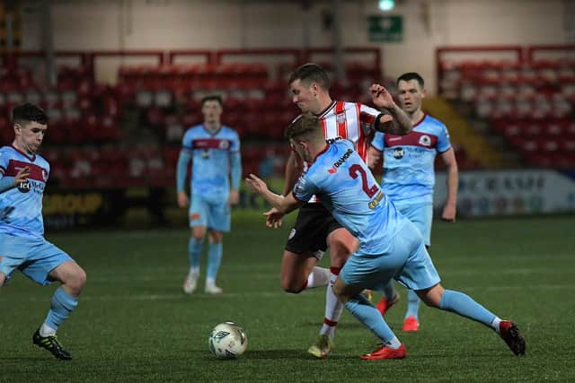 Institute’s Orin McLaughlin and Caoimhin tackle Derry City’s Patrick McEleney. Photograph: George Sweeney.