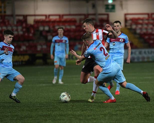 Institute’s Orin McLaughlin and Caoimhin tackle Derry City’s Patrick McEleney. Photograph: George Sweeney.