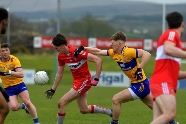 Derry’s Paul Cassidy is challenged by Clare’s Dermot Coughlan at Owenbeg on Sunday afternoon.  Photo: George Sweeney. DER2312GS – 02