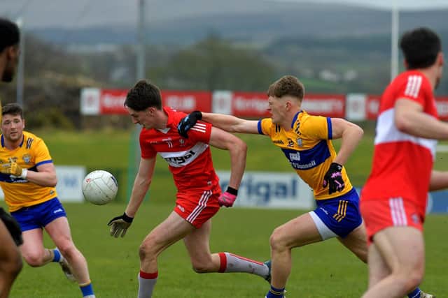 Derry’s Paul Cassidy is challenged by Clare’s Dermot Coughlan at Owenbeg on Sunday afternoon. Photo: George Sweeney. DER2312GS – 02