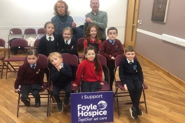 Una O’Somachain (McCafferty school of Music)  presenting a cheque for £300 to Noel McMonagle, Foyle Hospice, proceeds of a recent McCafferty school of music performance by the children.
