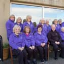 Members of the Purple Hearts group pictured with Father Gerard Mongan.