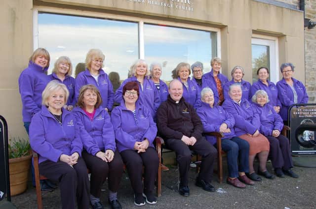 Members of the Purple Hearts group pictured with Father Gerard Mongan.
