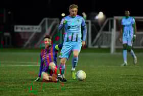 Institute’s Evan Tweed slips a tackle from Ards captain Eamon Scannell. Photo: George Sweeney