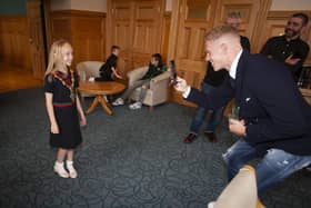 Wigan and Republic of Ireland footballer James McClean takes a photo of daughter Allie Mae in the Mayor’s chain at the civic reception in the Guildhall in recognition of his 100th cap for the Republic of Ireland.