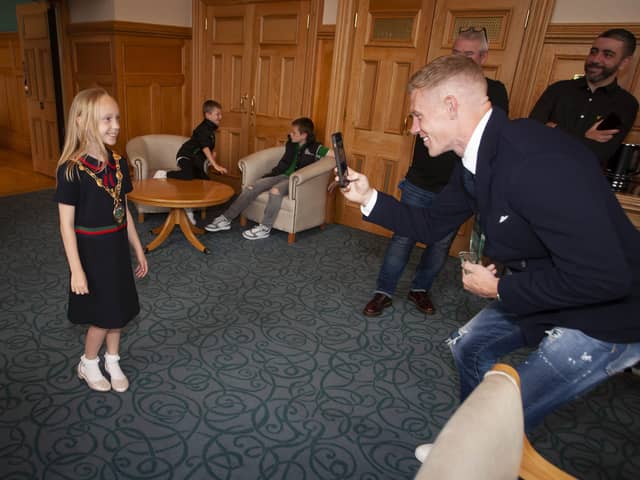 Wigan and Republic of Ireland footballer James McClean takes a photo of daughter Allie Mae in the Mayor’s chain at the civic reception in the Guildhall in recognition of his 100th cap for the Republic of Ireland.