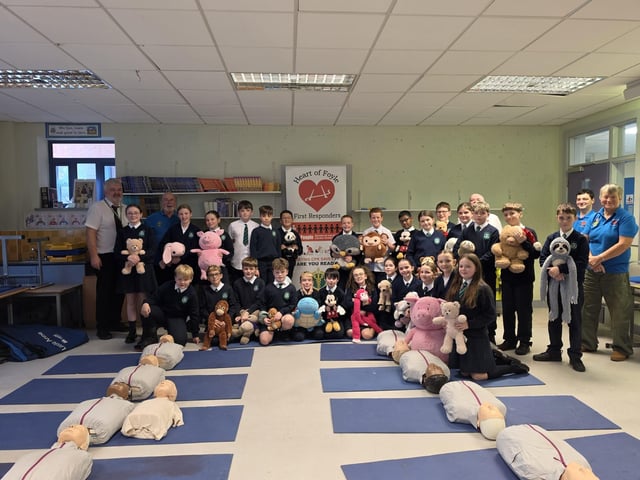 Heart of Foyle volunteers with pupils and staff at Saint Patrick's Primary School, Pennyburn.