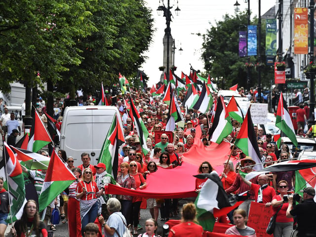 The ‘Turn Shipquay Street Red for Gaza’ march makes its way down Shipquay Street on Saturday afternoon. Photo: George Sweeney