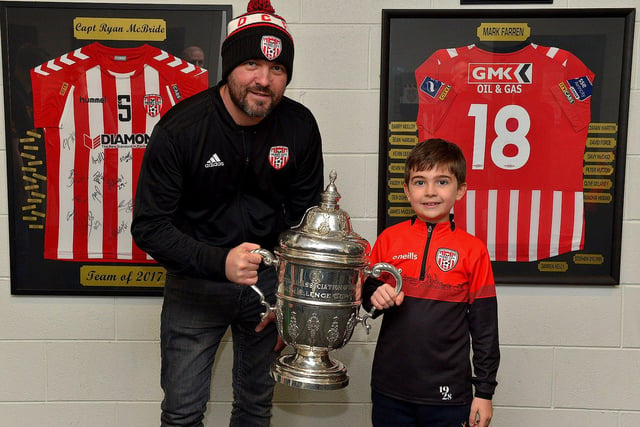 Derry City fans Cree Beagan and his dad Peter pictured with the FAI Cup at the Ryan McBride Brandywell Stadium on Thursday evening last.