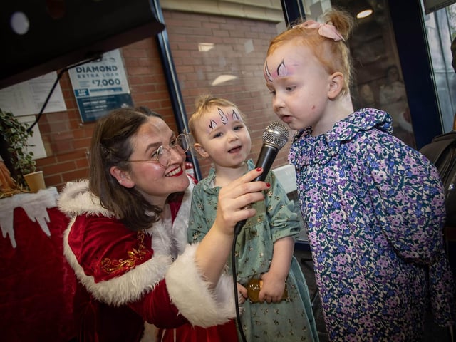Mrs. Claus singing with some of the younger Derry Credit Union members on Saturday. : .