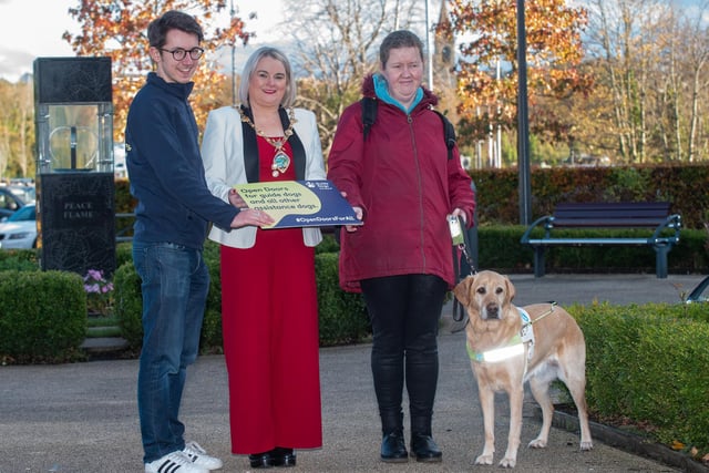 The Mayor Councillor Sandra Duffy pictured with Andrea O’Hagan and her Guide Dog Becky and Mark Quinn, Guide Dogs Marketing Manager as she helped promote Guide Dog Awareness and encourage people to open doors for assistance dogs. Picture Martin McKeown. 14.11.22
