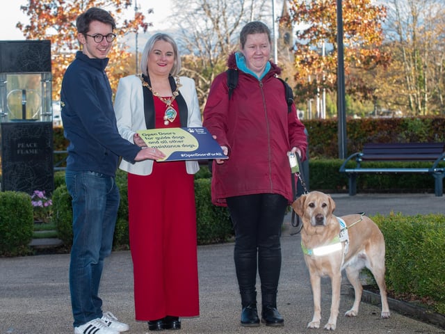 The Mayor Councillor Sandra Duffy pictured with Andrea O’Hagan and her Guide Dog Becky and Mark Quinn, Guide Dogs Marketing Manager as she helped promote Guide Dog Awareness and encourage people to open doors for assistance dogs. Picture Martin McKeown. 14.11.22
