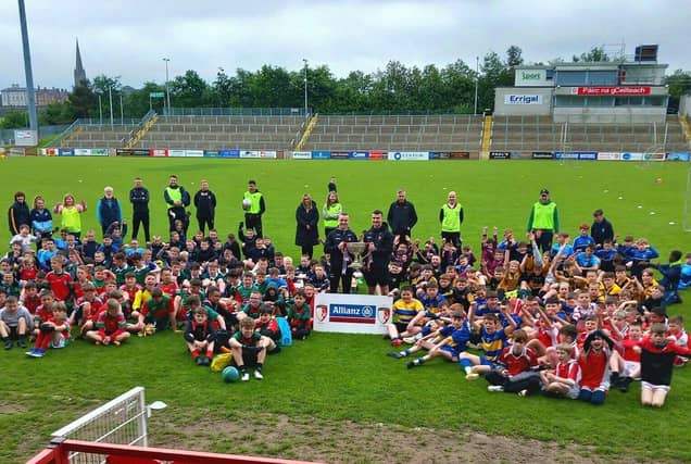 Schools competing in the Tower Cup Boy’s Finals in Celtic Park picture with Derry seniors Cahir McMonagle and Diarmuid Baker and the Division One National League Trophy. Photo: courtesy of Francis Mallon