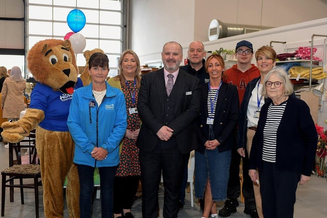Foyle Hospice staff and volunteers pictured at the official opening of the Hospice Shop in Pennyburn Industrial Estate.  From left are Hospice Harry, Sarah Jane, Ailbhe, Donal Henderson, CEO, David, Shops Manager Jackie McMonagle, Mateusz, Sheila and Angela. Photo: George Sweeney