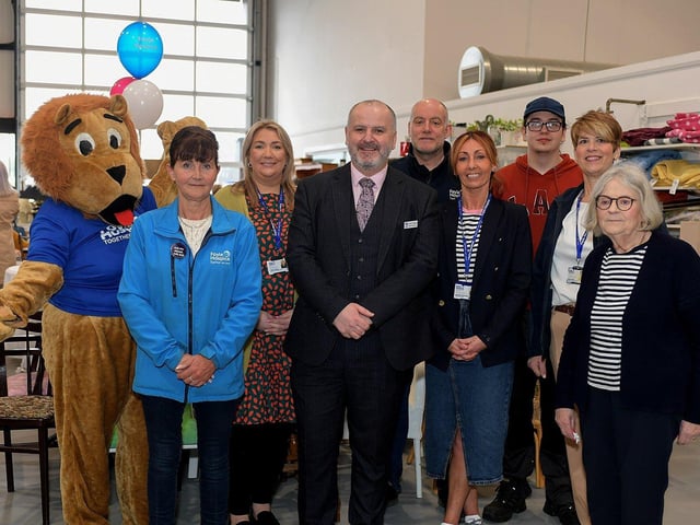 Foyle Hospice staff and volunteers pictured at the official opening of the Hospice Shop in Pennyburn Industrial Estate. From left are Hospice Harry, Sarah Jane, Ailbhe, Donal Henderson, CEO, David, Shops Manager Jackie McMonagle, Mateusz, Sheila and Angela. Photo: George Sweeney