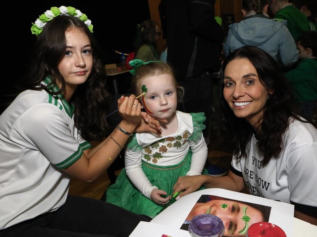 Face painter Elmer McNamara with Terri Gannon and her daughter Billie who is celebrating her 1st St. Patrick’s Day at An Cultúrlann, after flying in from Dubai last week, (Photo - Tom Heaney, nwpresspics)