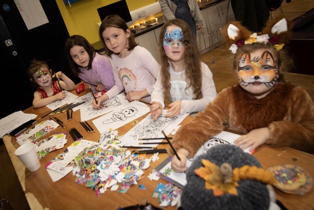 Children enjoying some colouring-in at the Feile/Surestart (Edenballymore) Halloween Fun Day at the Long Tower Youth Club on Monday afternoon.