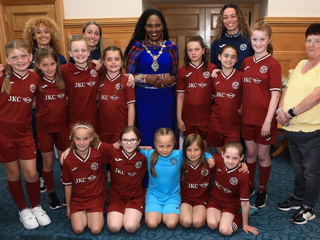 Mayor Lilian Barr recently held a reception for Newbuildings Under 11 girls football team who, after 23 years of participation in the Derry and District Youth League, have for the first time won a trophy. Standing, back from left, are coaches Sienna Leckey, Zahara Leckey, Ebony Leckey and Jayne McKeegan, head of youth, Newbuildings FC. (Photo - Tom Heaney, nwpresspics)