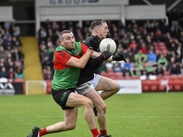 Doire Trasna’s Flynn Doherty and Oran Carton of Slaughtmanus battle for possession. Photo: George Sweeney