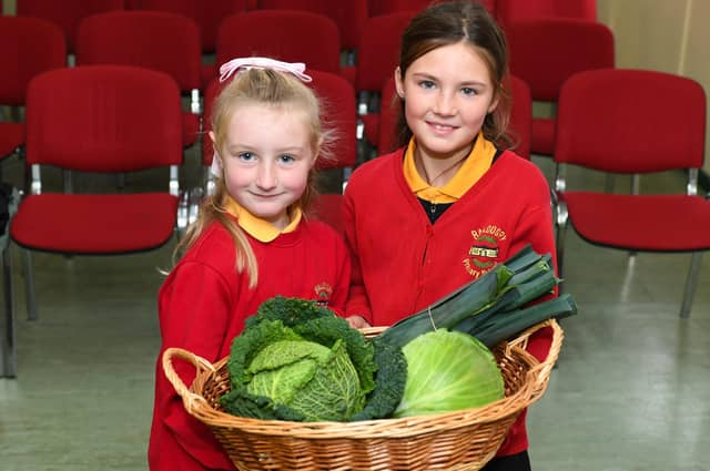 Ballougry Primary School pupils Raeya (P5) and Grace (P4) pictured at the Harvest Assembly and Food Bank held in the school on Wednesday morning. Photo: George Sweeney