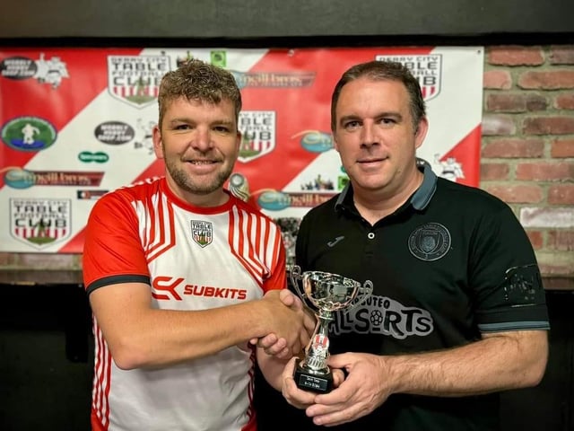 Lawrence Watson, Derry City Table Football Club, presenting the runner-up award in the Irish International Open individual competition to Wolfgang Haas.