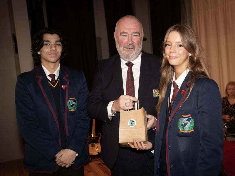 The Head Boy and Head Girl make a presentation to Mr. John Shiels, special guest speaker at the Oakgrove Integrated College prizegiving.