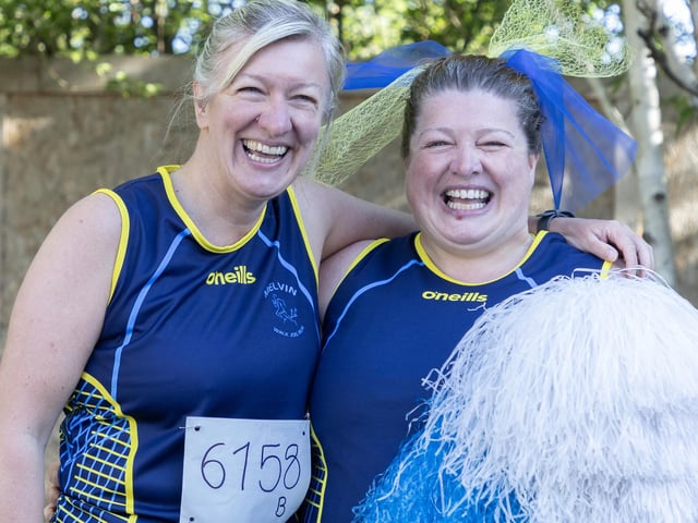 Carrie Us Over the Line relay team having a laugh at the finish line.