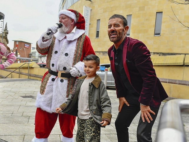 Santa, Miles Keogh and Mickey Doherty sing along at the Richmond Shopping Centre on Sunday afternoon. Photo: George Sweeney