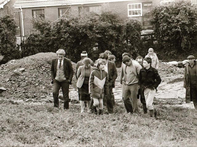 John Tierney with residents assessing flood damage.
