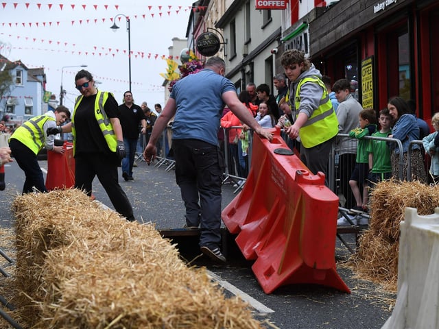 Officials prepare the Soap Box Derby course, in Carndonagh, on Saturday afternoon. Photo: George Sweeney
