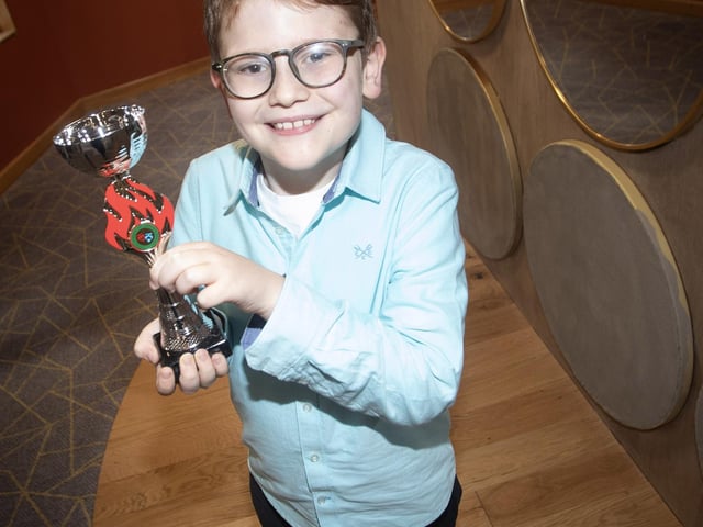 P5 Pupil Eamon Herr proudly holds aloft his trophy on Saturday. : Foyle School of Speech and Drama's fantastic annual charity feis for the Foyle Hospice