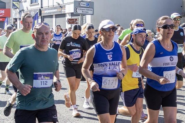 Liam Cleary (left) and two Finn Valley runners make their way through the streets of Strabane on Sunday.