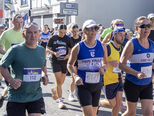 Liam Cleary (left) and two Finn Valley runners make their way through the streets of Strabane on Sunday.