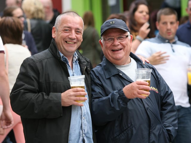 Two of the locals enjoy the craic in Waterloo Street during Sunday's Fleadh opening. DER3313JM024