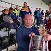 Slaughtneil captain Brendan Rogers freceives the Fr. Collins Cup after his side's victory over Kevin Lynch's in Owenbeg on Sunday.
