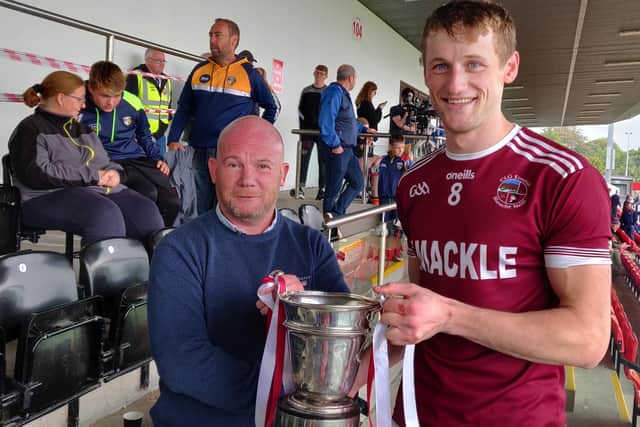 Slaughtneil captain Brendan Rogers freceives the Fr. Collins Cup after his side's victory over Kevin Lynch's in Owenbeg on Sunday.