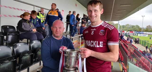 Slaughtneil captain Brendan Rogers freceives the Fr. Collins Cup after his side's victory over Kevin Lynch's in Owenbeg on Sunday.