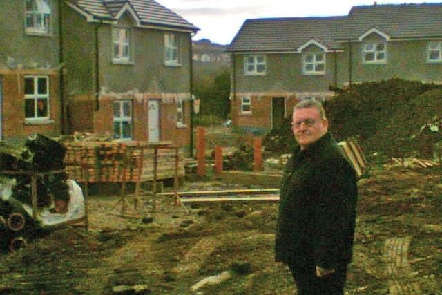 Tony Hassan looking at progress of new houses for Travellers at Ballyarnett.