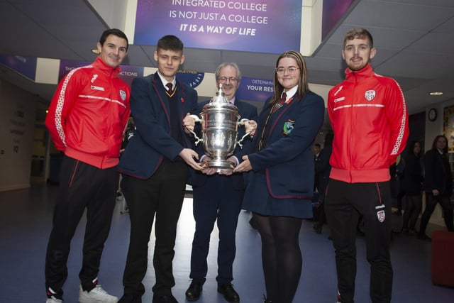 Mr. John Harkin, Oakgrove Integrated College Acting Principal with Head Boy Jay Burke and Head Girl Tia Kincaid pictured with the FAI Cup, brought to the school by Derry City players Ciaran Coll and Jamie McGonigle.
