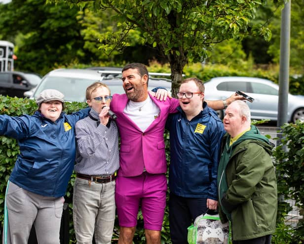 Micky Doherty with people supported by Praxis Care.
