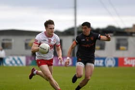 Derry’s Ethan Doherty slips a tackle from Rory Grugan of Armagh. Photo: George Sweeney