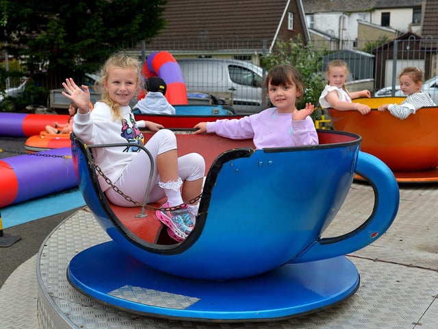 Avery and Saorise enjoy a spin in the tea cup at the Pennyburn Youth Club fun day on Friday afternoon last. Photo: George Sweeney. DER2331GS – 101