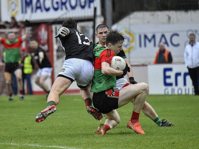 Slaughtmanus pair Killene Thornton and Cahir Cooke attempt to dispossess Doire Trasna’s Cormac Kelly . Photo: George Sweeney
