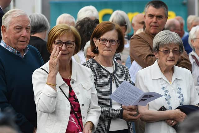 People gather for a service in Claudy marking the 52nd anniversary of the car bombings that killed nine people and injured 30 others. Photo: George Sweeney